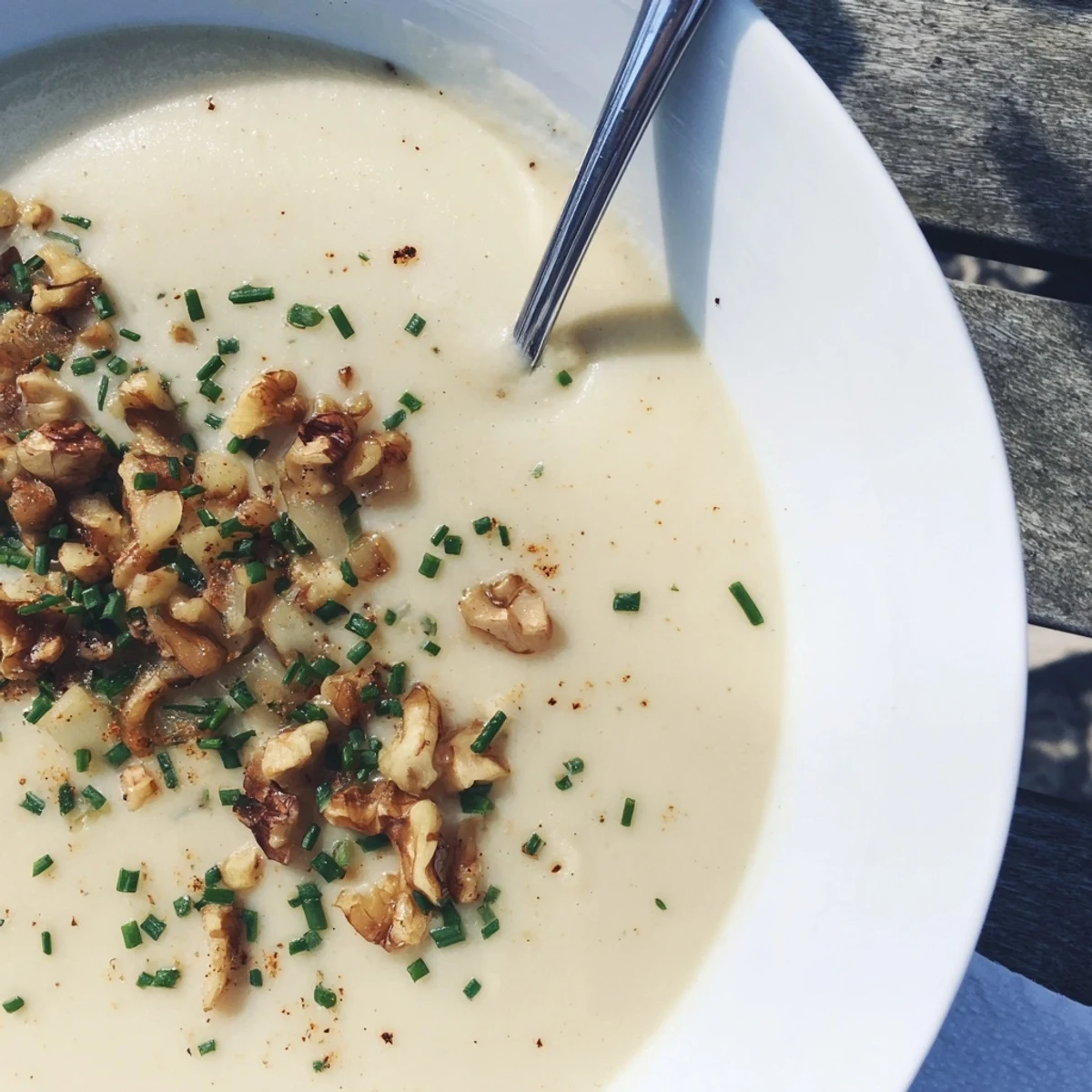 A silky, warmly spiced Creamy Parsnip and Pear Soup with a glossy finish and walnut topping.