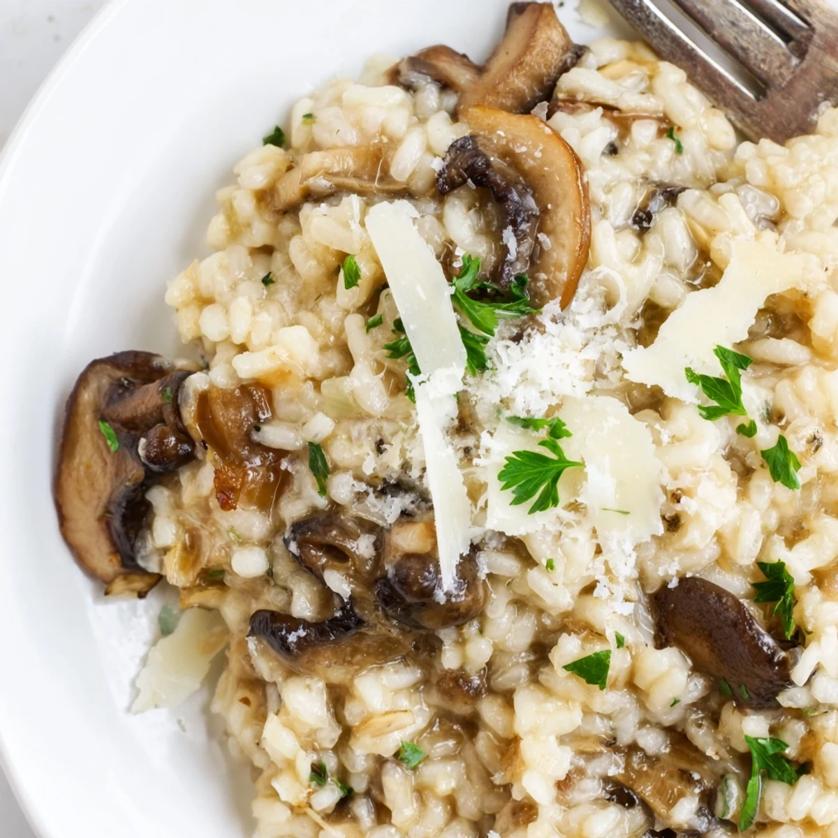 Close-up of Creamy Mushroom Risotto with Truffle Oil showing its velvety texture, Parmesan, and glossy truffle oil drizzle.
