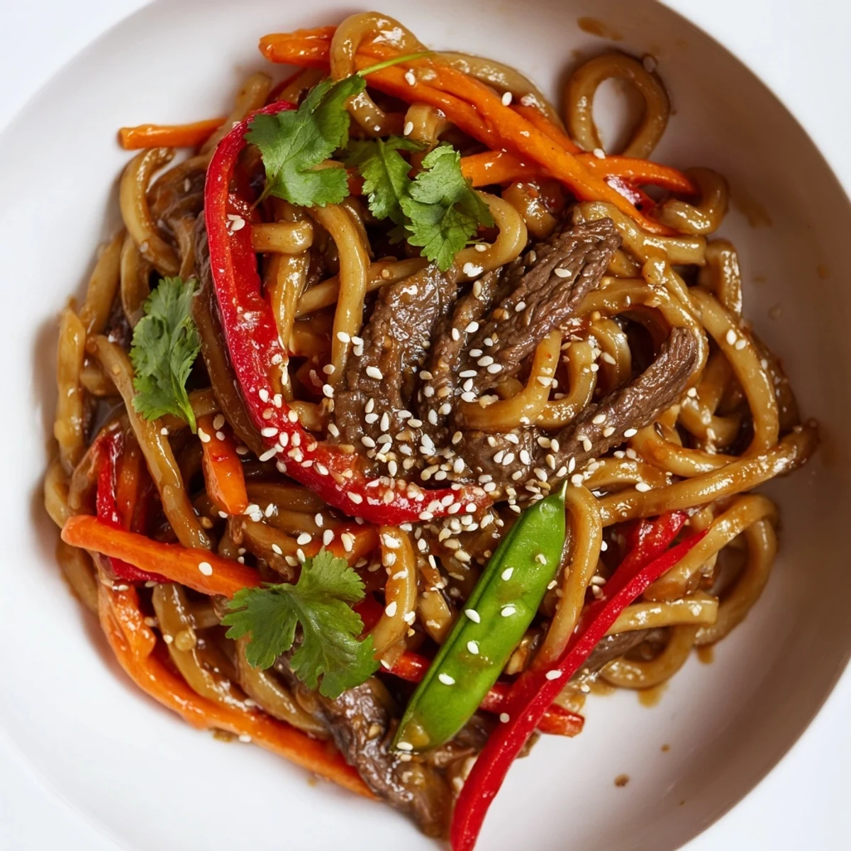 Steaming bowl of homemade Spicy Beef Noodles with tender beef and crisp vegetables.