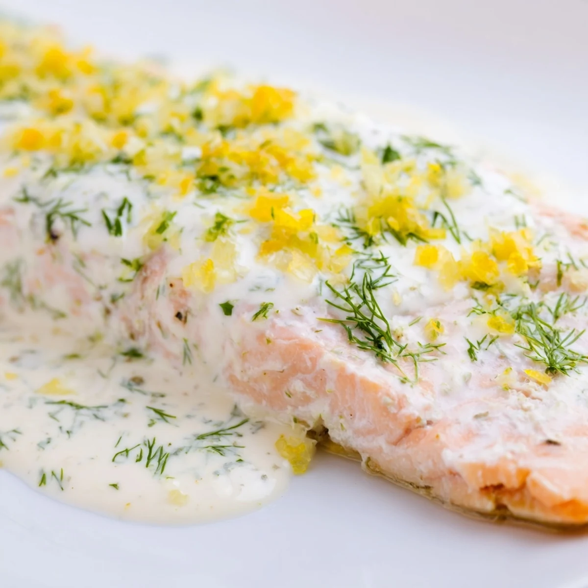 Golden Baked Salmon with Garlic Butter and Dill Sauce plated with herbs, perfect for a weeknight dinner.