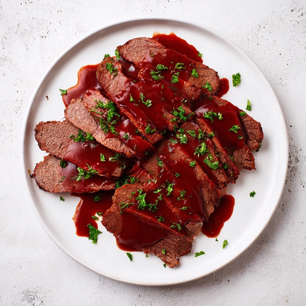 Golden-brown Slow Cooker Beef Brisket, shredded and mixed with tangy BBQ sauce, ideal for sandwiches or plated with mashed potatoes.