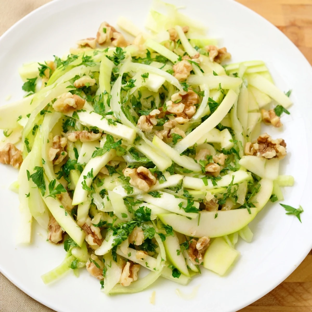 Close-up of Green Apple and Celery Salad, showcasing thin celery, tart apple slices, and a drizzled zesty dressing.