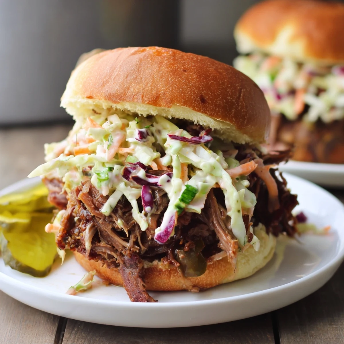 A juicy, slow-cooked beef brisket slider with fresh coleslaw, perfect for game day or family gatherings.