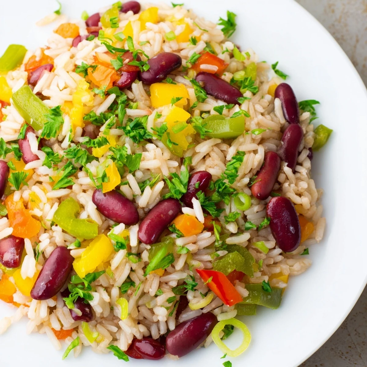 Hearty Mardi Gras Rice and Beans served in a bowl with a side of cornbread for a festive meal.