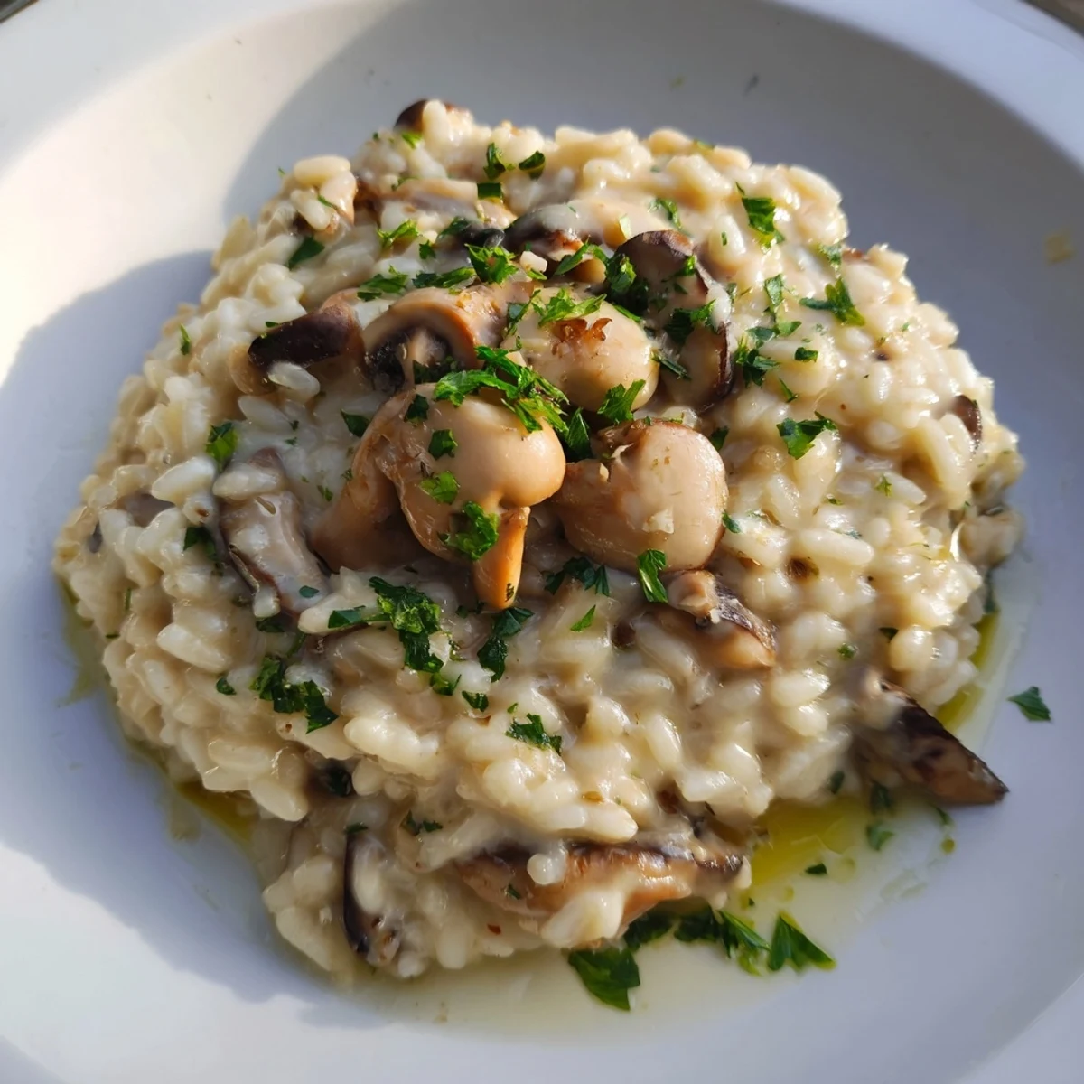 Earthy aroma of sautéed mushrooms in this Creamy Mushroom Risotto with Truffle Oil on a rustic wooden table.