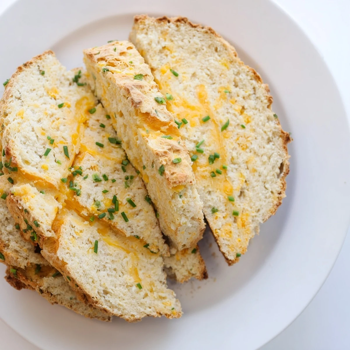 Fresh chives and sharp cheddar melt into the crumb of this beautiful Savory Cheddar & Chive Irish Soda Bread.