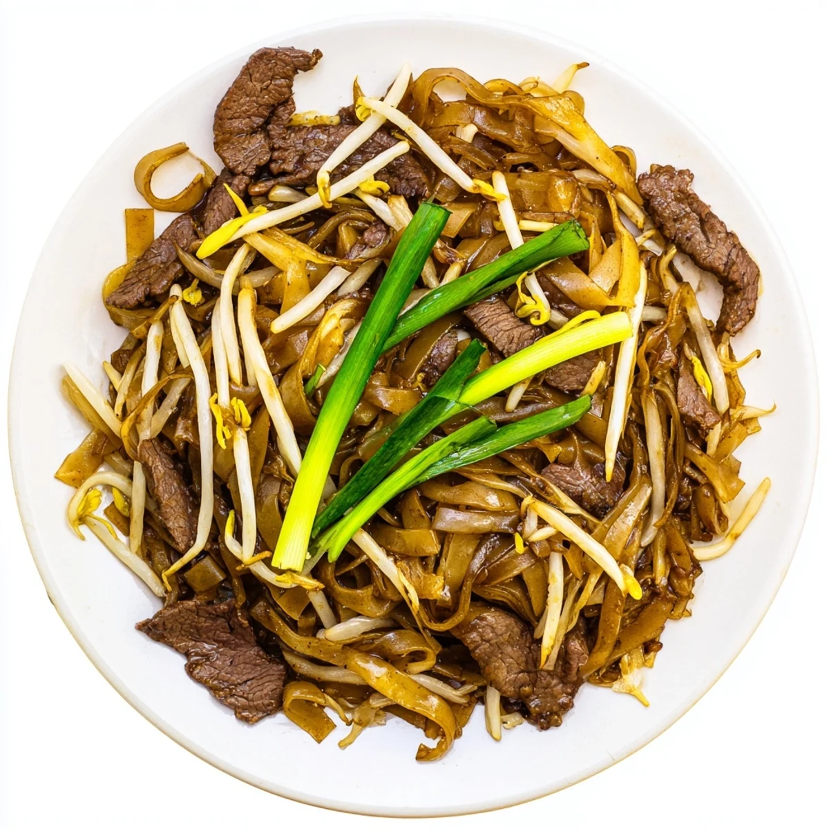 Sizzling Beef Chow Fun on a plate, with charred noodles, seared beef, and vibrant onions and bean sprouts.