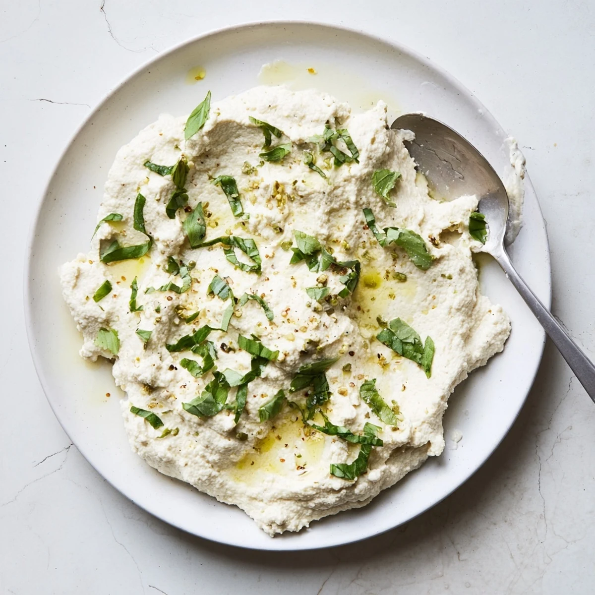 Golden vegan lasagna featuring layers of Tofu Ricotta and bubbling marinara sauce.