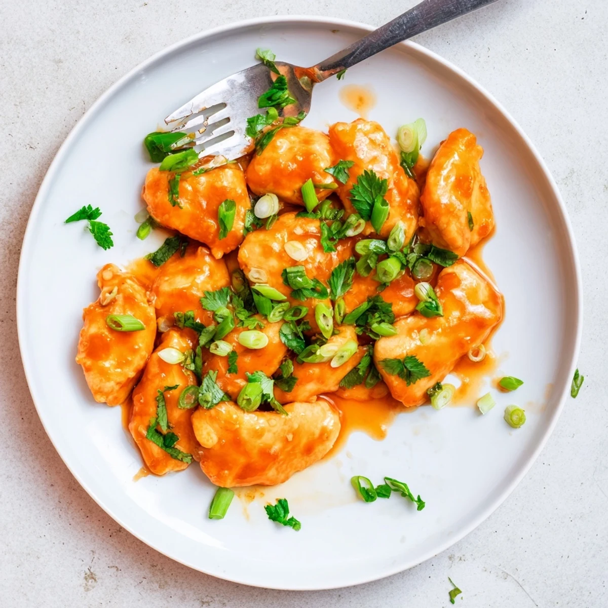 Golden-brown Classic Apricot Chicken breasts glazed in sticky, tangy apricot sauce in a white skillet.