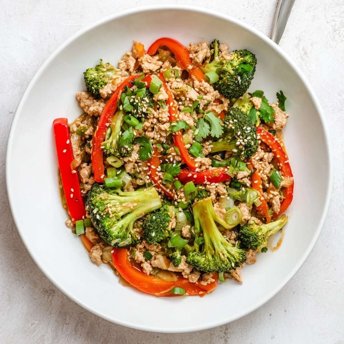 Golden brown ground turkey stir fry with broccoli coated in savory glossy sauce