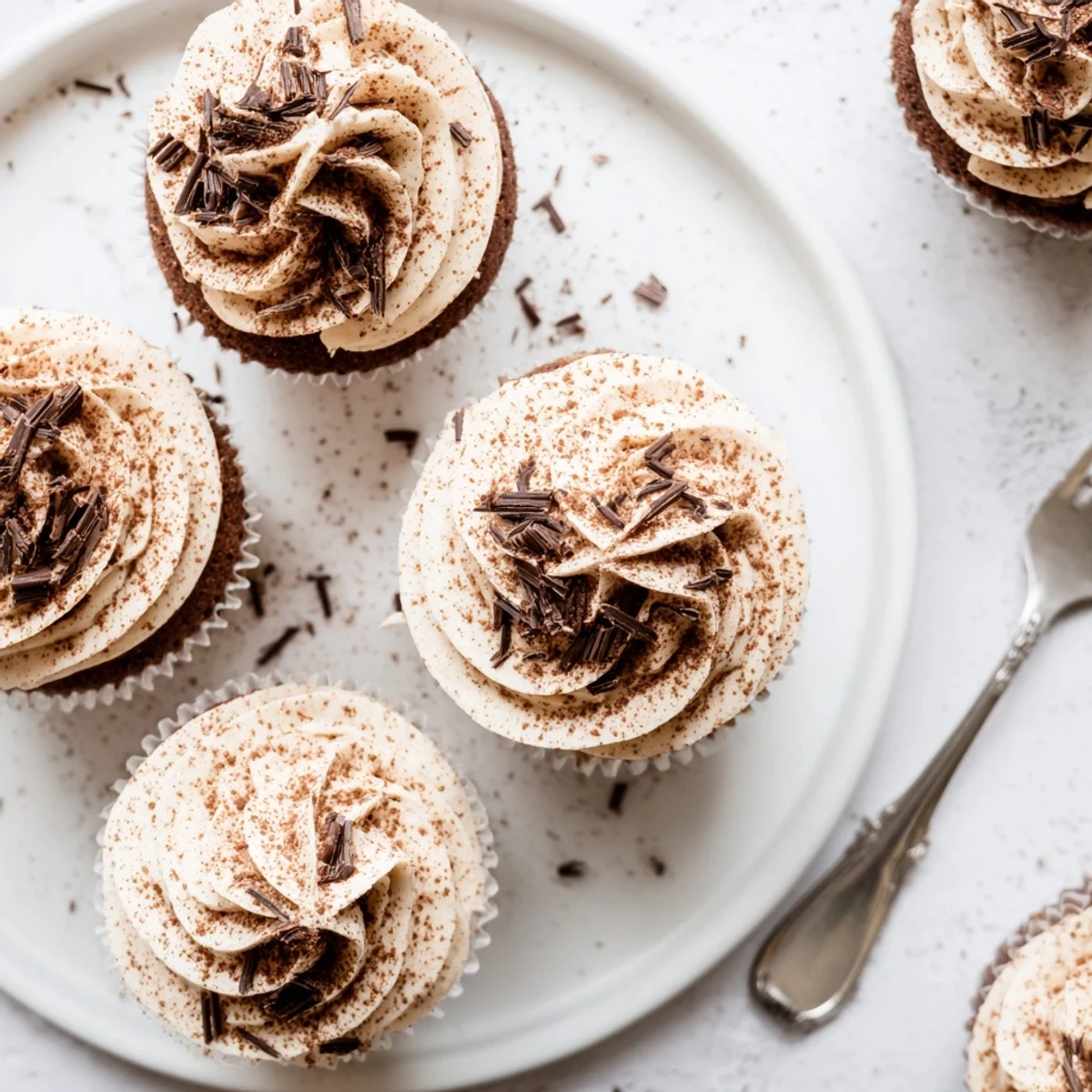 Decadent chocolate cupcakes soaked in coffee syrup with creamy mascarpone and chocolate shavings
