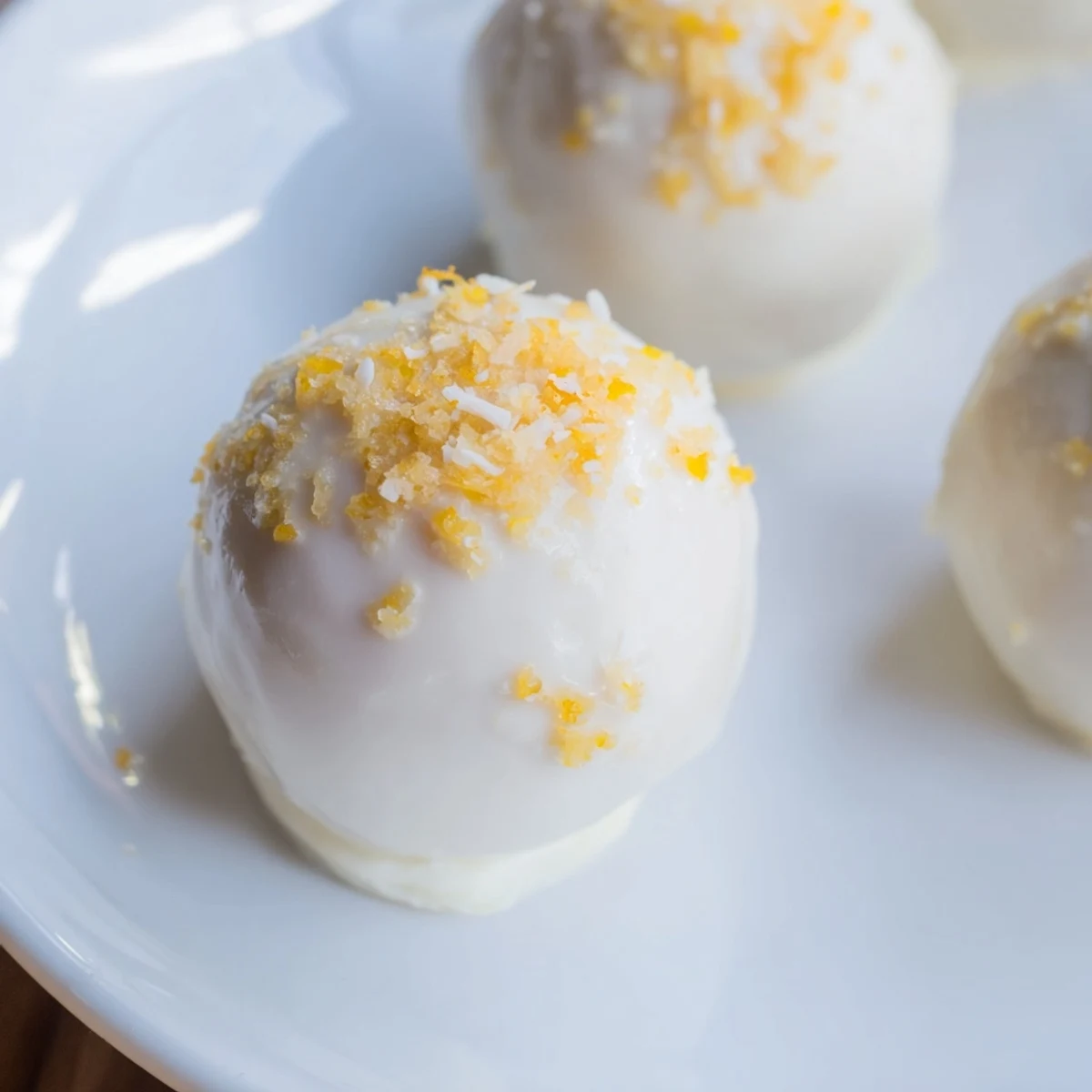 Bite-sized mango truffles with smooth white chocolate ganache center and dried mango topping