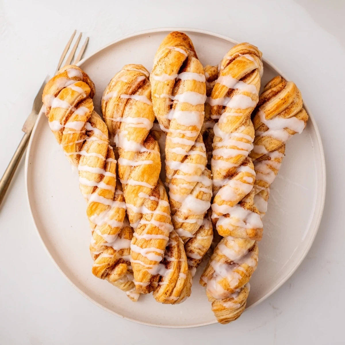 Freshly baked sweet cinnamon twists showing spiral cinnamon sugar filling and golden crust