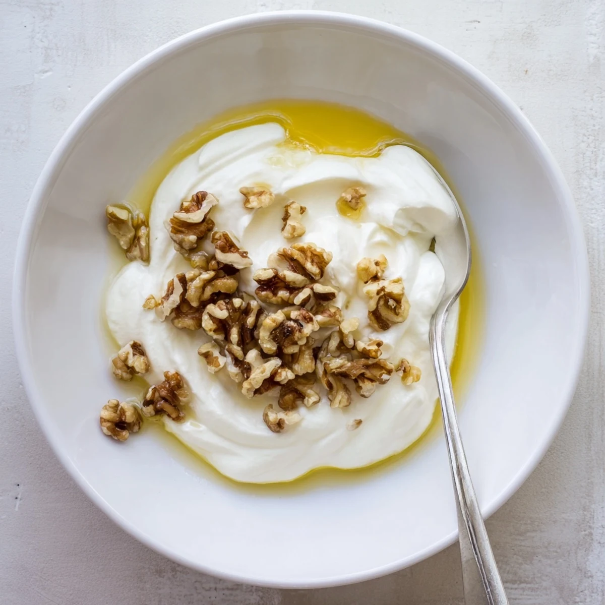 Rich strained Greek yogurt recipe served with granola and vibrant mixed fruit toppings