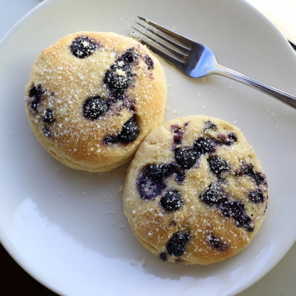 Golden blueberry biscuits fresh from the oven with scattered sugar on top