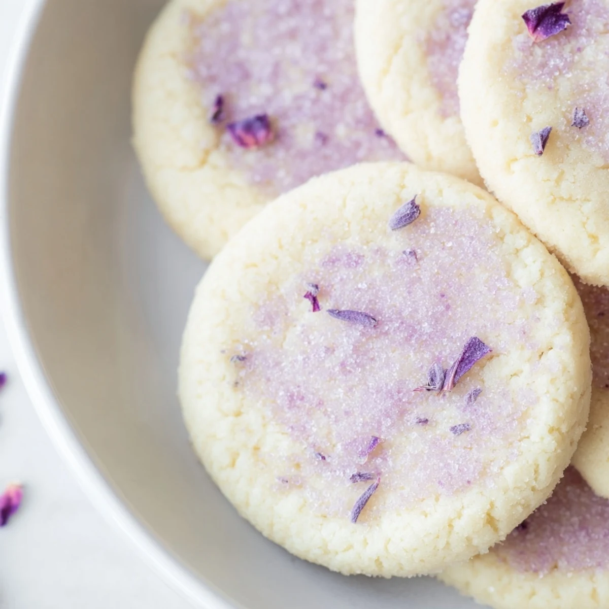 Soft lilac sugar cookies with pale purple edges cooling on a wire rack