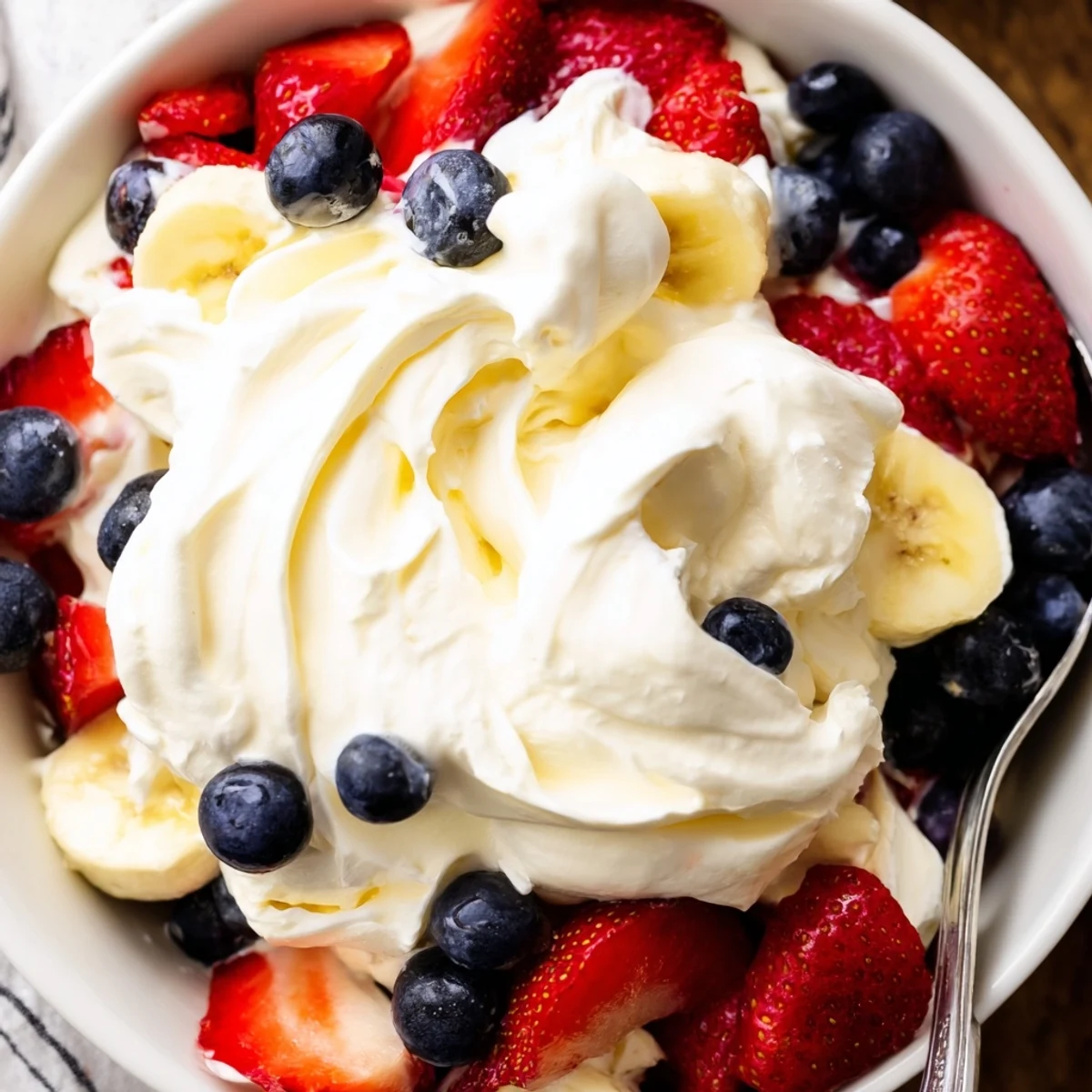 Chilled Red White And Blue Cheesecake Salad ready for Fourth of July picnic.