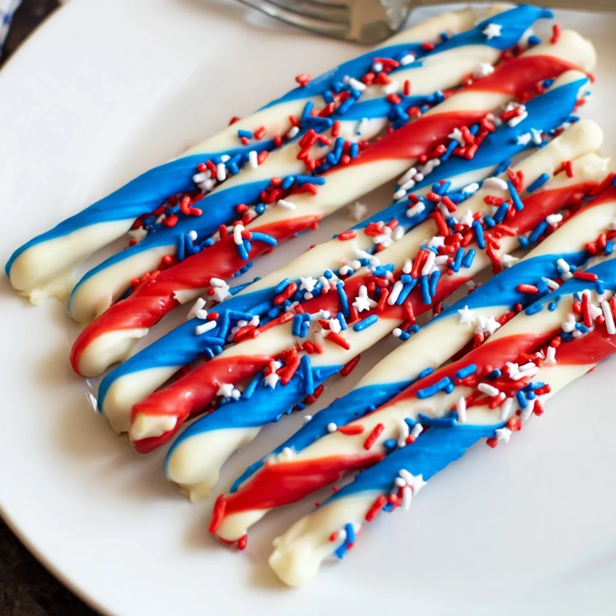 Close-up of Patriotic Pretzel Rods with glossy chocolate stripes and crunchy pretzel rod
