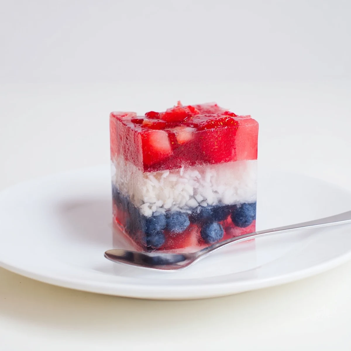 Red White And Blue Ice Cubes Recipe showing glossy fruit layers chilling sparkling water