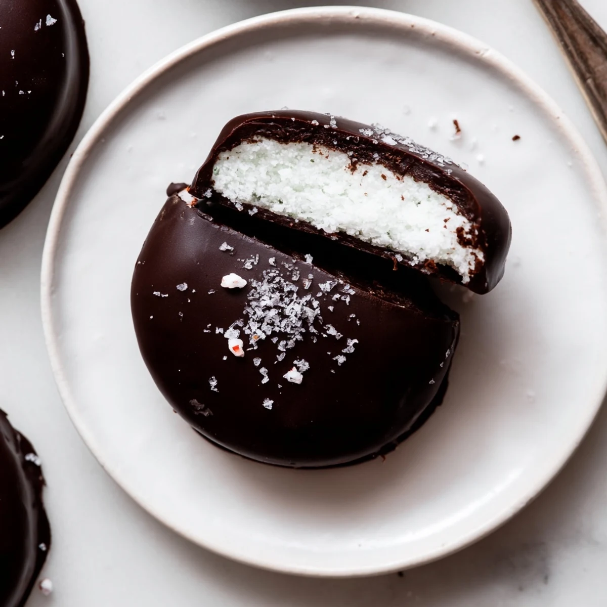 Stacked Peppermint Patties garnished with crushed candy, rich chocolate sheen