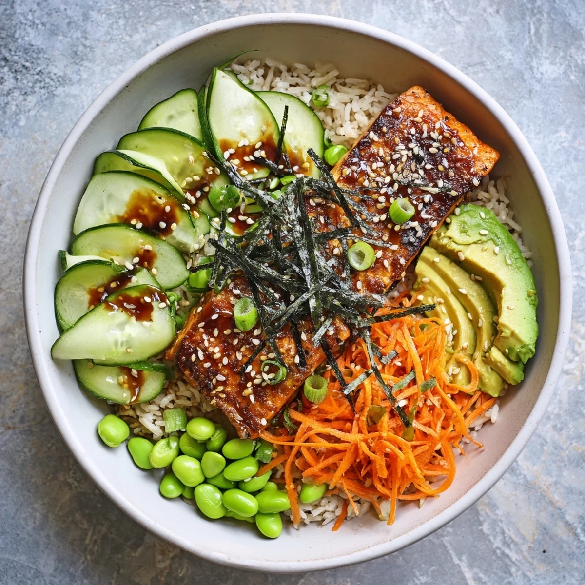 Golden crispy salmon fillet with crunchy skin resting on fluffy jasmine rice with fresh cucumber and avocado slices