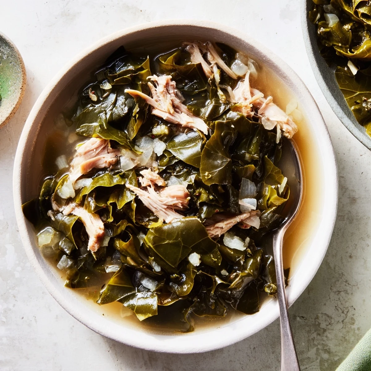 Classic Southern collard greens cooked to perfection in a cast iron pot with rich dark broth