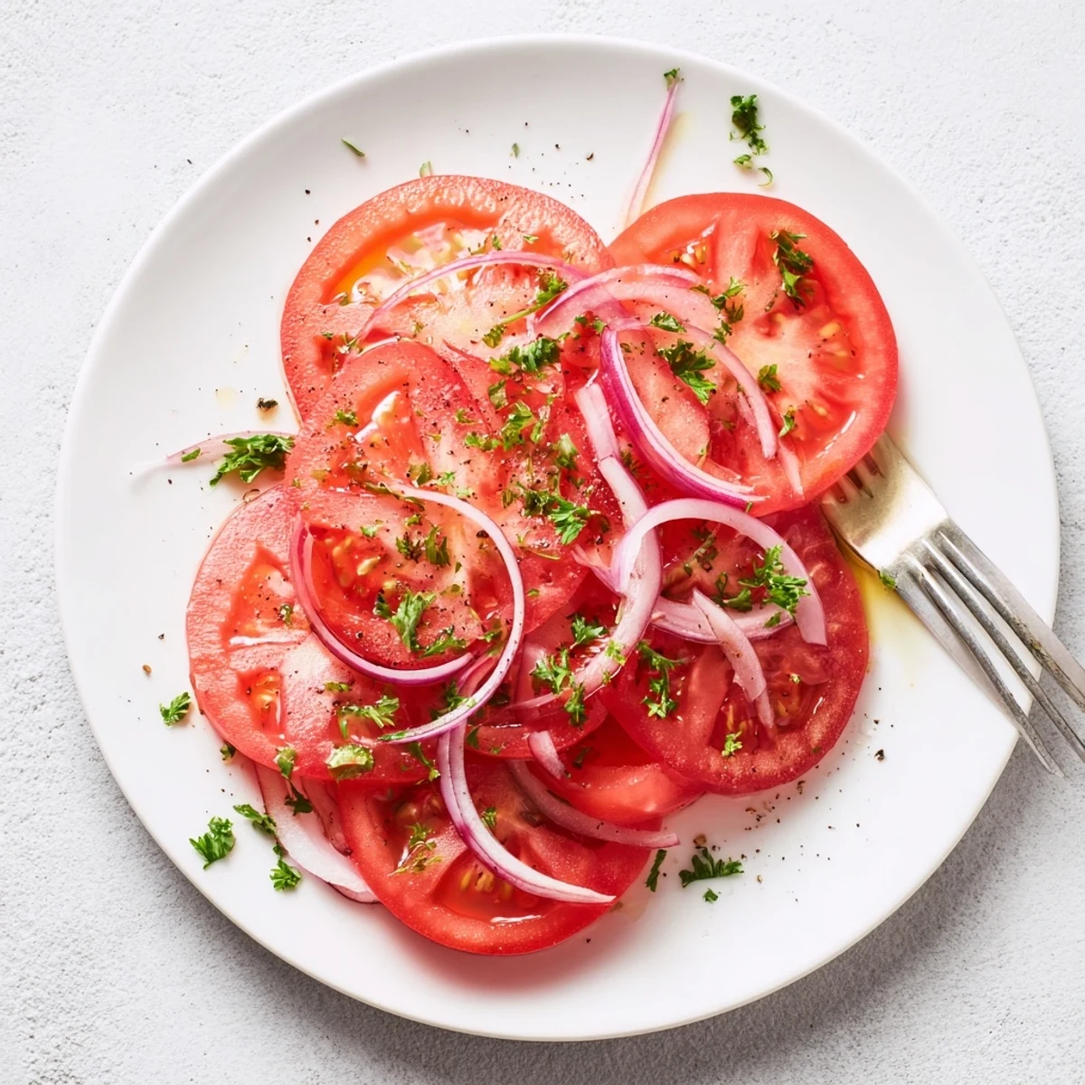 Crisp tomato and onion salad topped with fresh parsley in a refreshing Mediterranean style