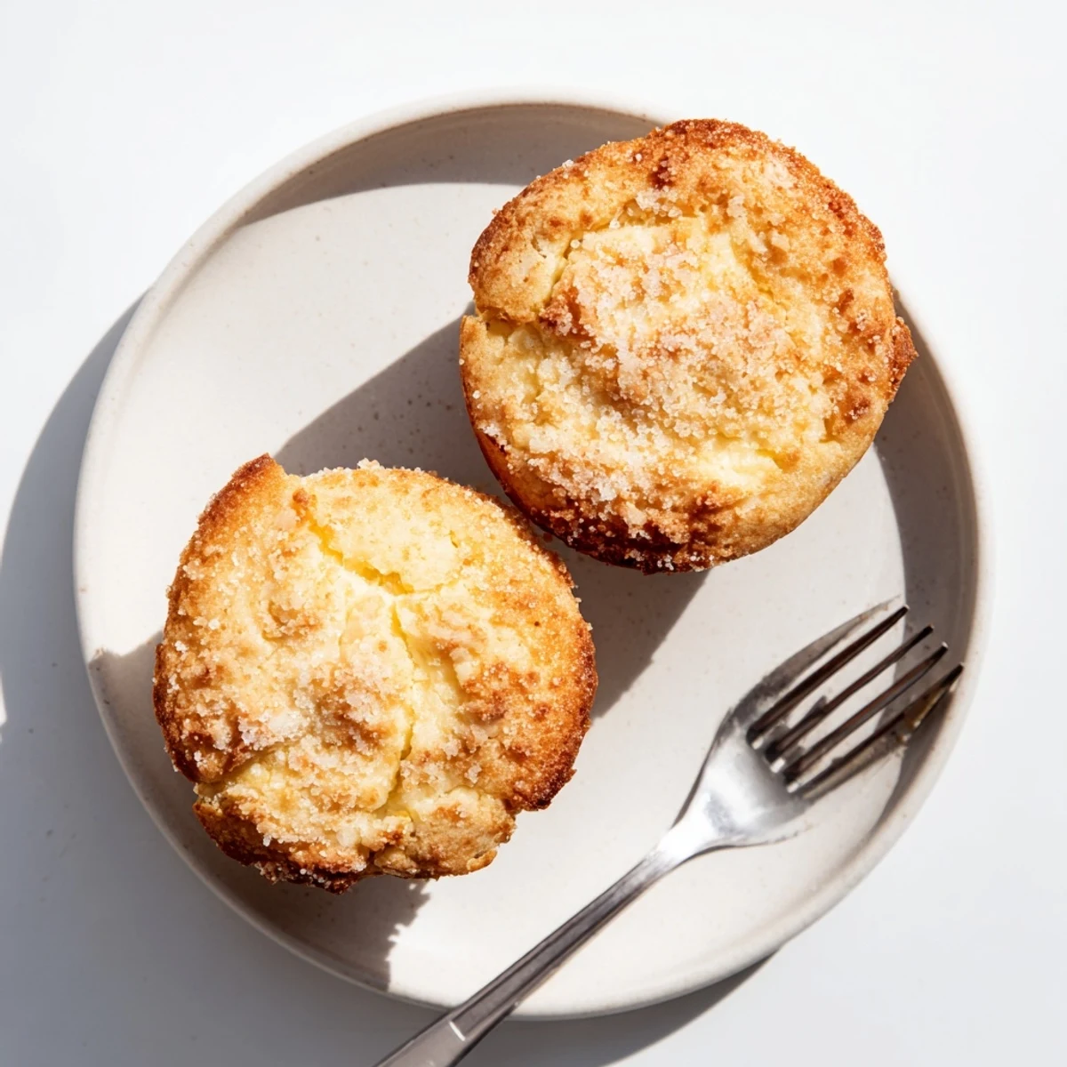 Freshly baked lemon cream cheese muffins with moist crumb and creamy center filling