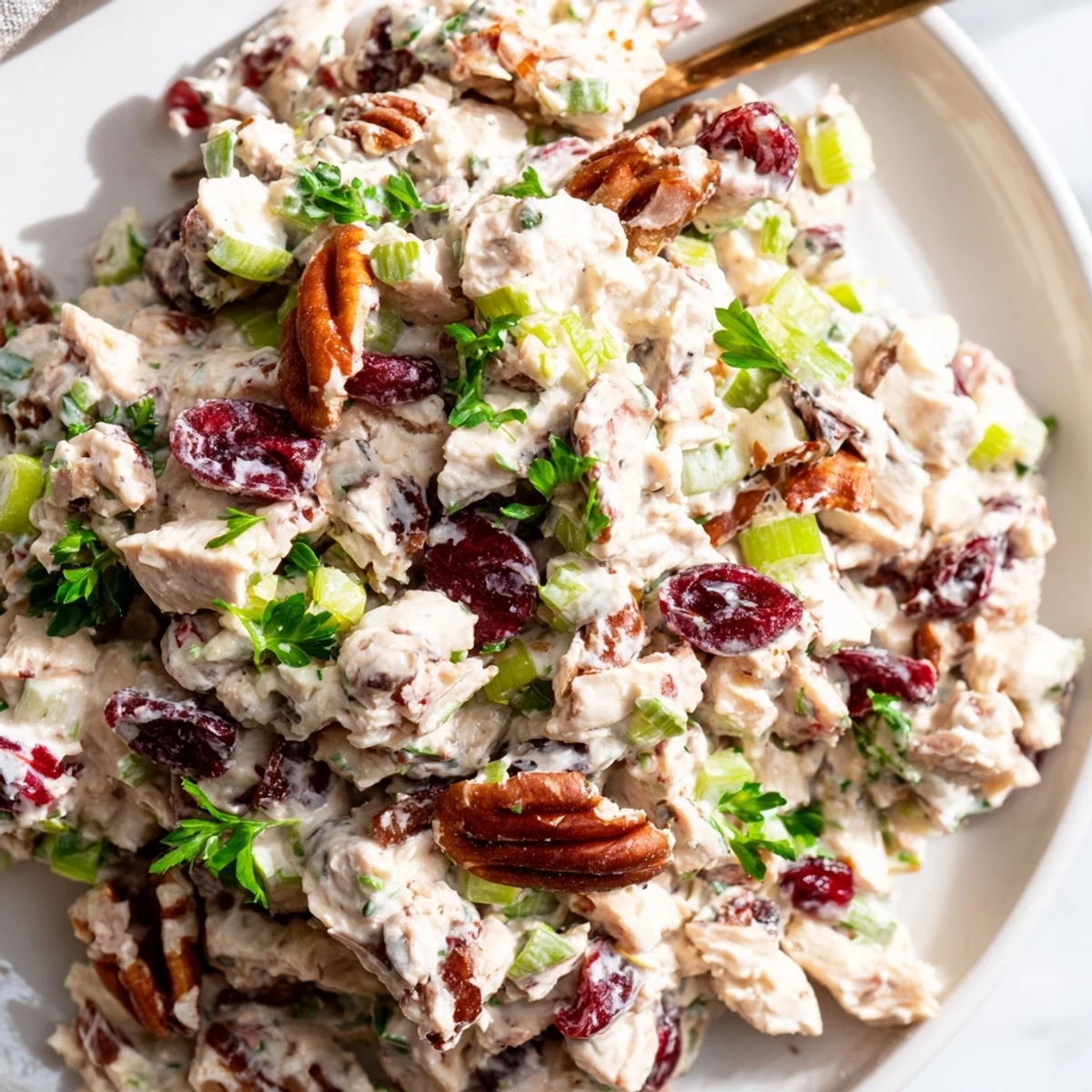 Chicken salad bowl with cranberries and pecans ready for serving on croissants or fresh greens