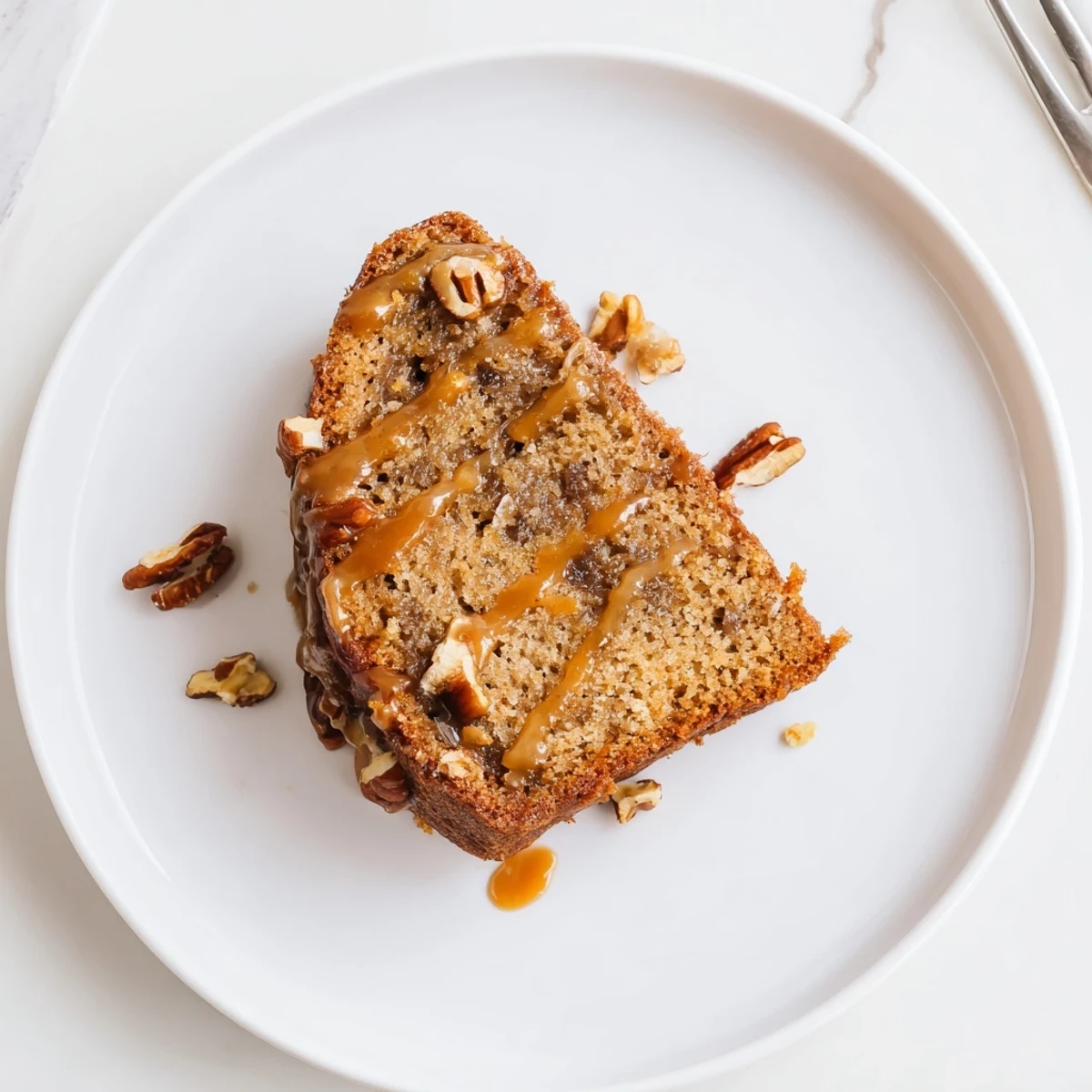 Moist banana cake swirled with rich salted caramel on a white plate