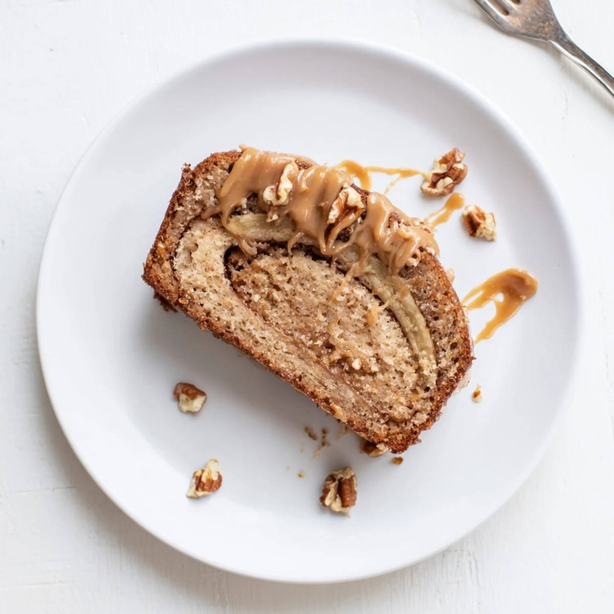 Decadent brown butter banana cake topped with flaky sea salt and caramel sauce