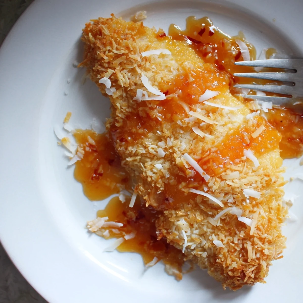 Coconut Chicken With Apricot Sauce on white plate, crispy, fragrant, served with rice