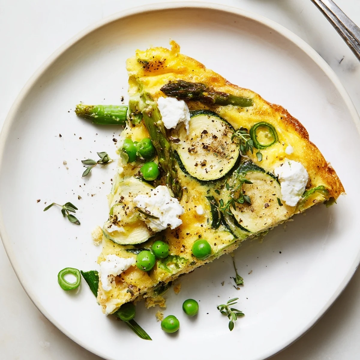 Spring Vegetable Frittata With Goat Cheese with golden edges and tender asparagus
