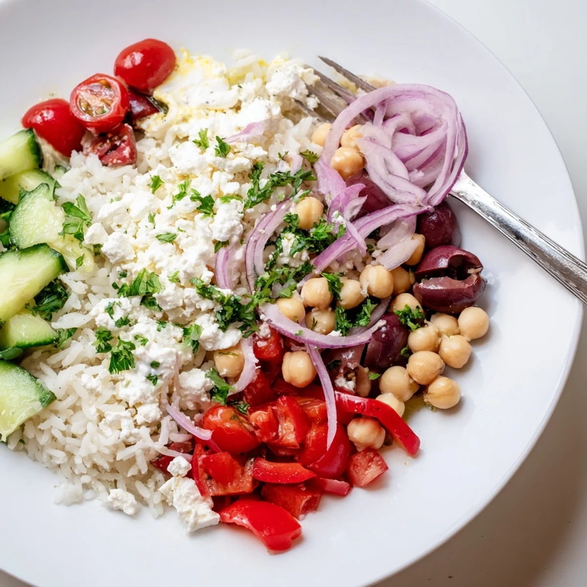 Steaming Mediterranean rice bowl drizzled with creamy lemon tahini dressing and fresh herbs